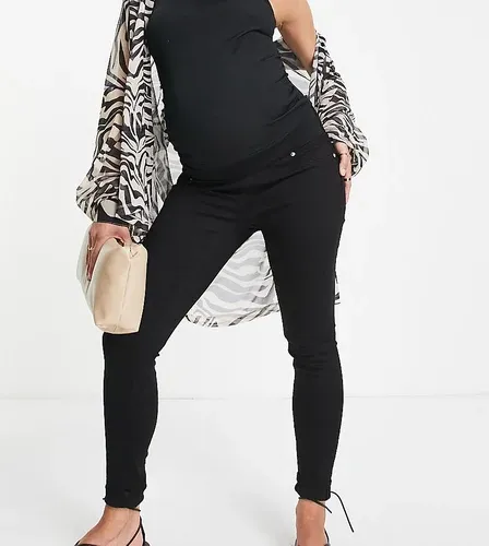 ASOS Maternity Vaqueros negro limpio de corte pitillo con cinturilla por debajo del vientre de ASOS DESIGN Maternity (8125721)